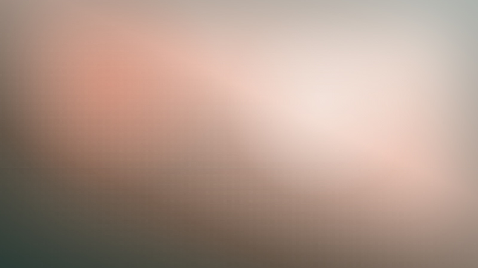 A calm open field of gentle colour under a steady, quiet light.
